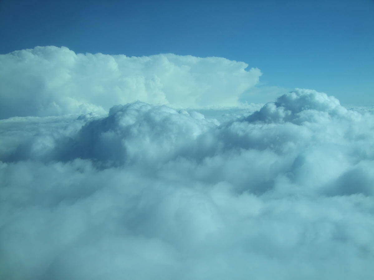 Photo taken from a jet of the top of cumulonimbus cloud developing an anvil top.