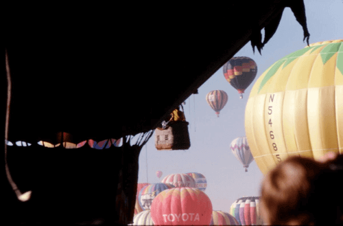 Photo of hot air balloons ascending.